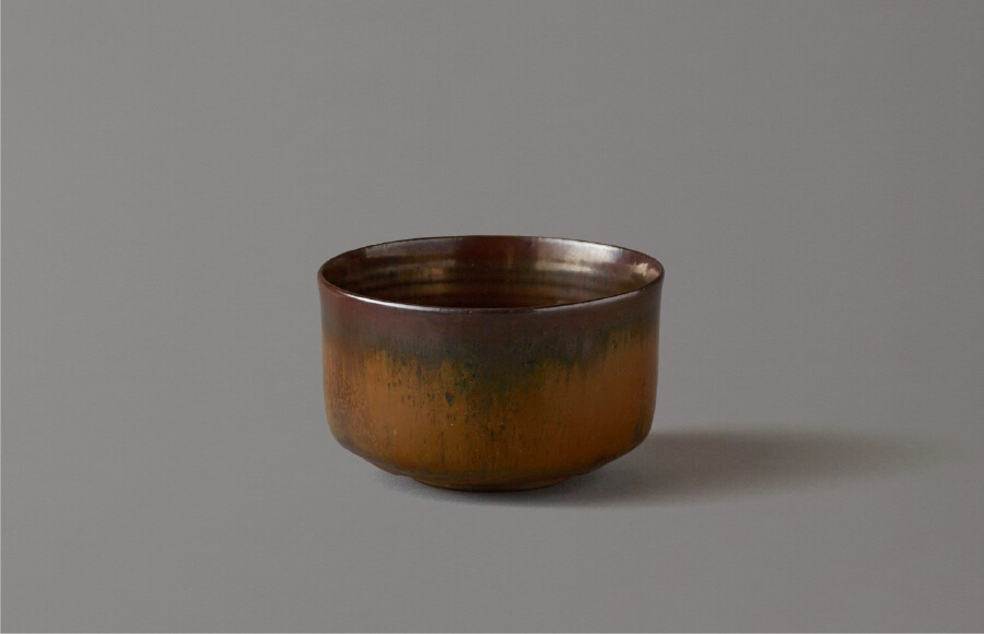 Takatori yellow-glazed tea bowl (black over yellow glaze)